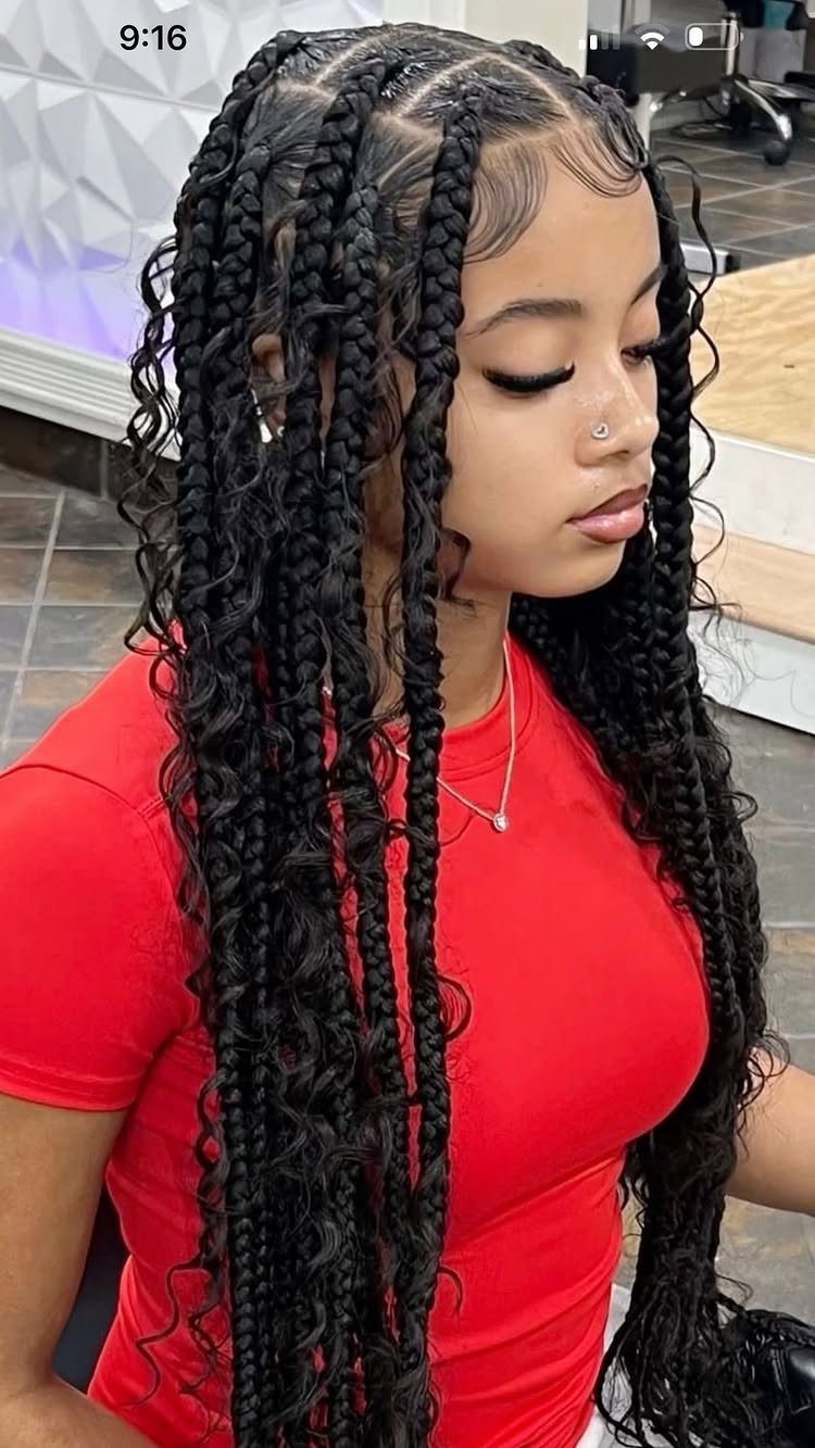 12 Braids Hairstyles: 29 Ideas, From Box Braids to Milkmaid 3 Young woman with black cornrows transitioning into long curly braids wearing a red shirt.