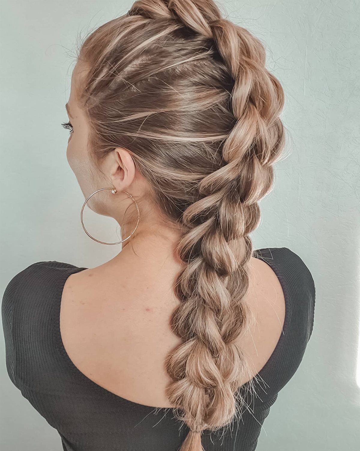 12 Braids Hairstyles: 29 Ideas, From Box Braids to Milkmaid 22 Blonde woman with a thick, voluminous dragon braid running down her back.