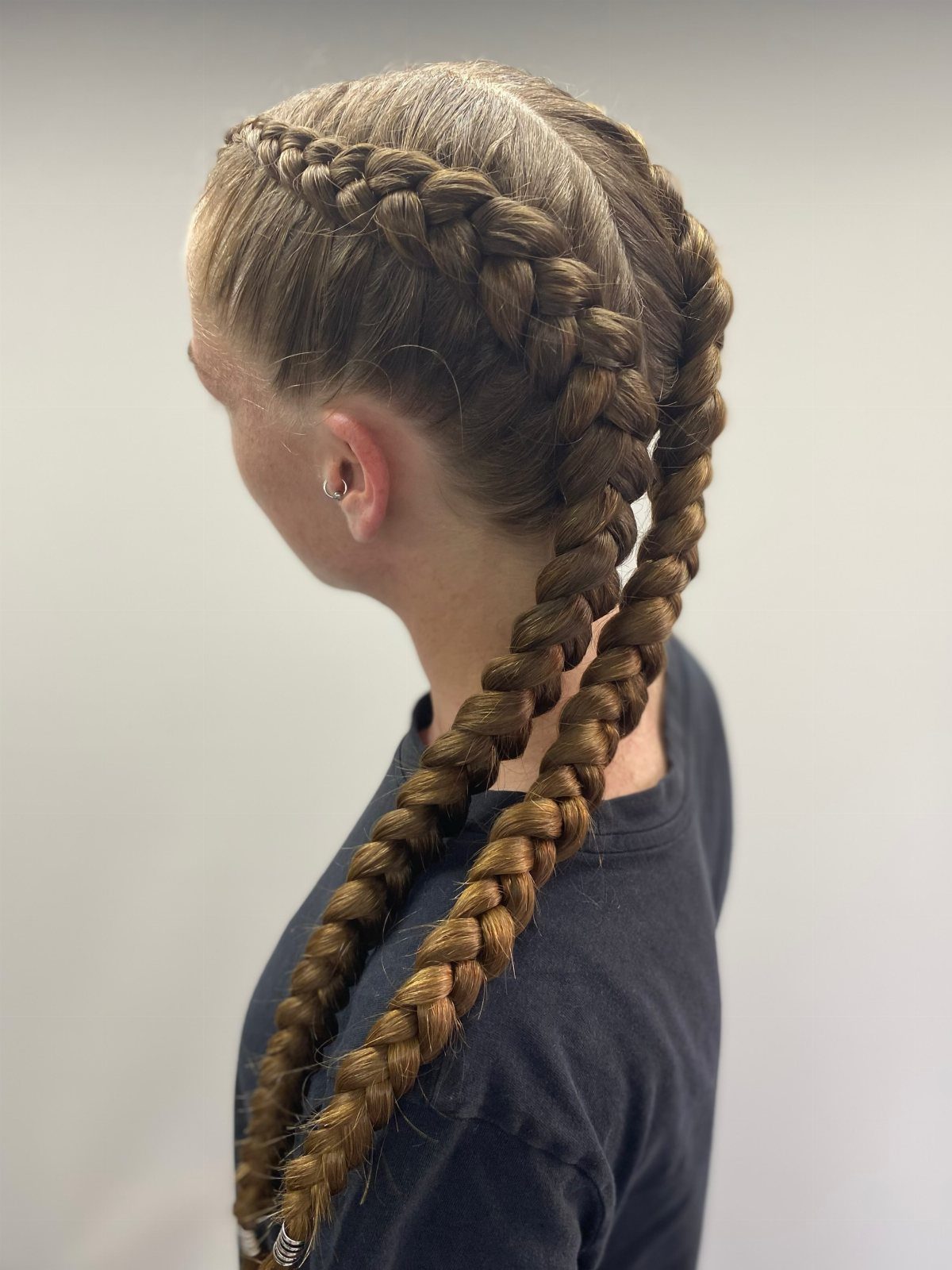 12 Braids Hairstyles: 29 Ideas, From Box Braids to Milkmaid 11 Two thick Dutch braids on light brown hair extending down the back.