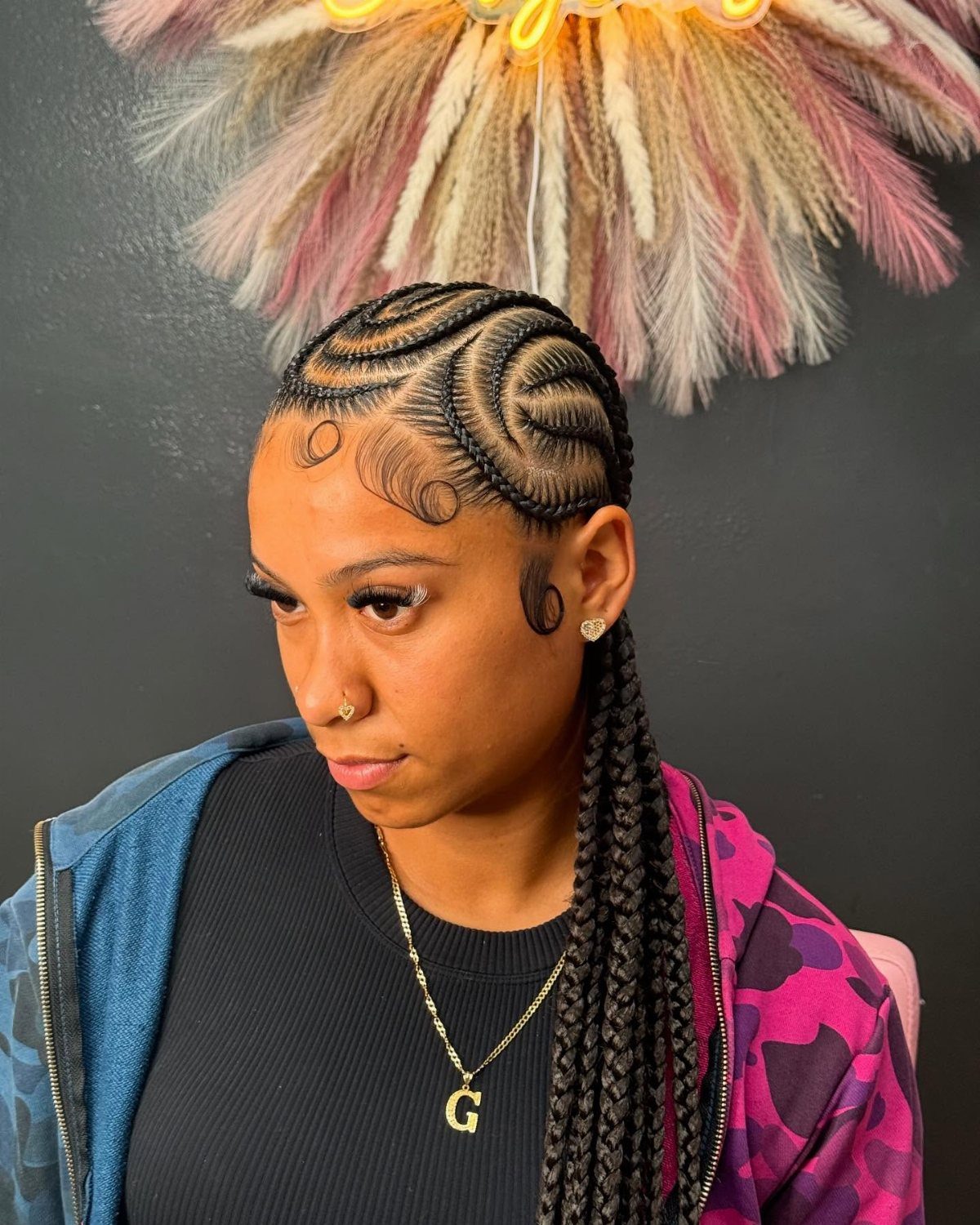12 Braids Hairstyles: 29 Ideas, From Box Braids to Milkmaid 25 Woman with intricate curved cornrow braids and long hanging braids wearing a gold necklace.