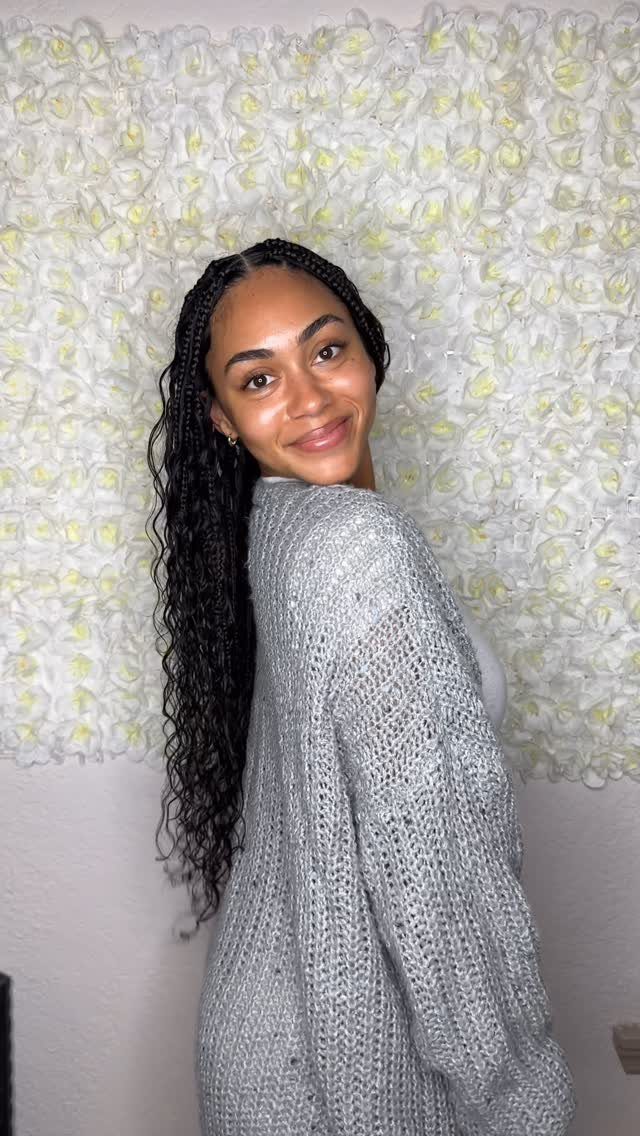 12 Braids Hairstyles: 29 Ideas, From Box Braids to Milkmaid 5 Woman with long dark goddess braids and curly ends against a white floral wall.