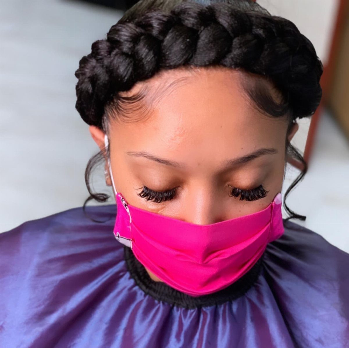 12 Braids Hairstyles: 29 Ideas, From Box Braids to Milkmaid 4 Woman with a thick halo braid crown wearing a pink face mask and purple cape.
