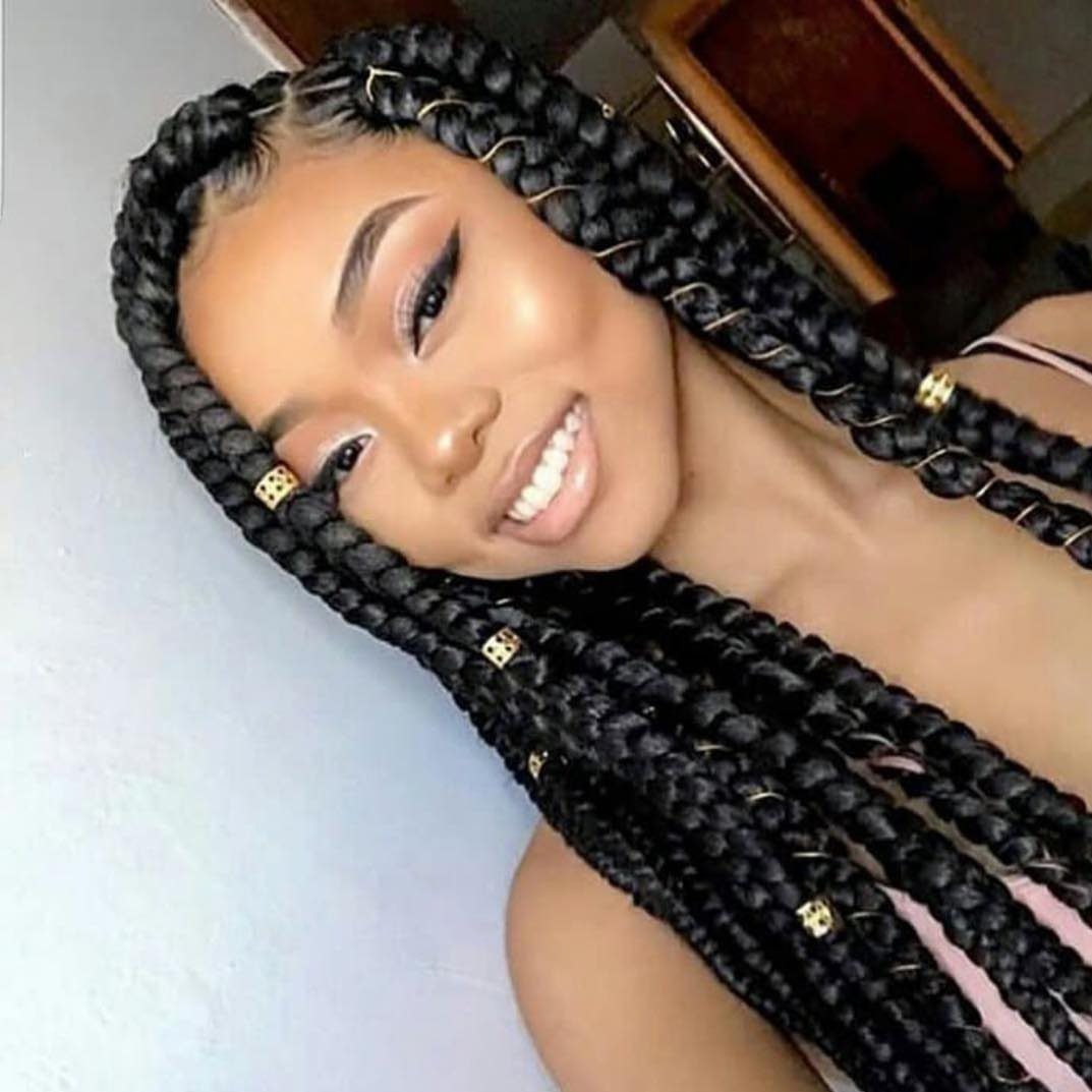 12 Braids Hairstyles: 29 Ideas, From Box Braids to Milkmaid 14 Woman with thick black jumbo box braids decorated with gold metallic hair cuffs.