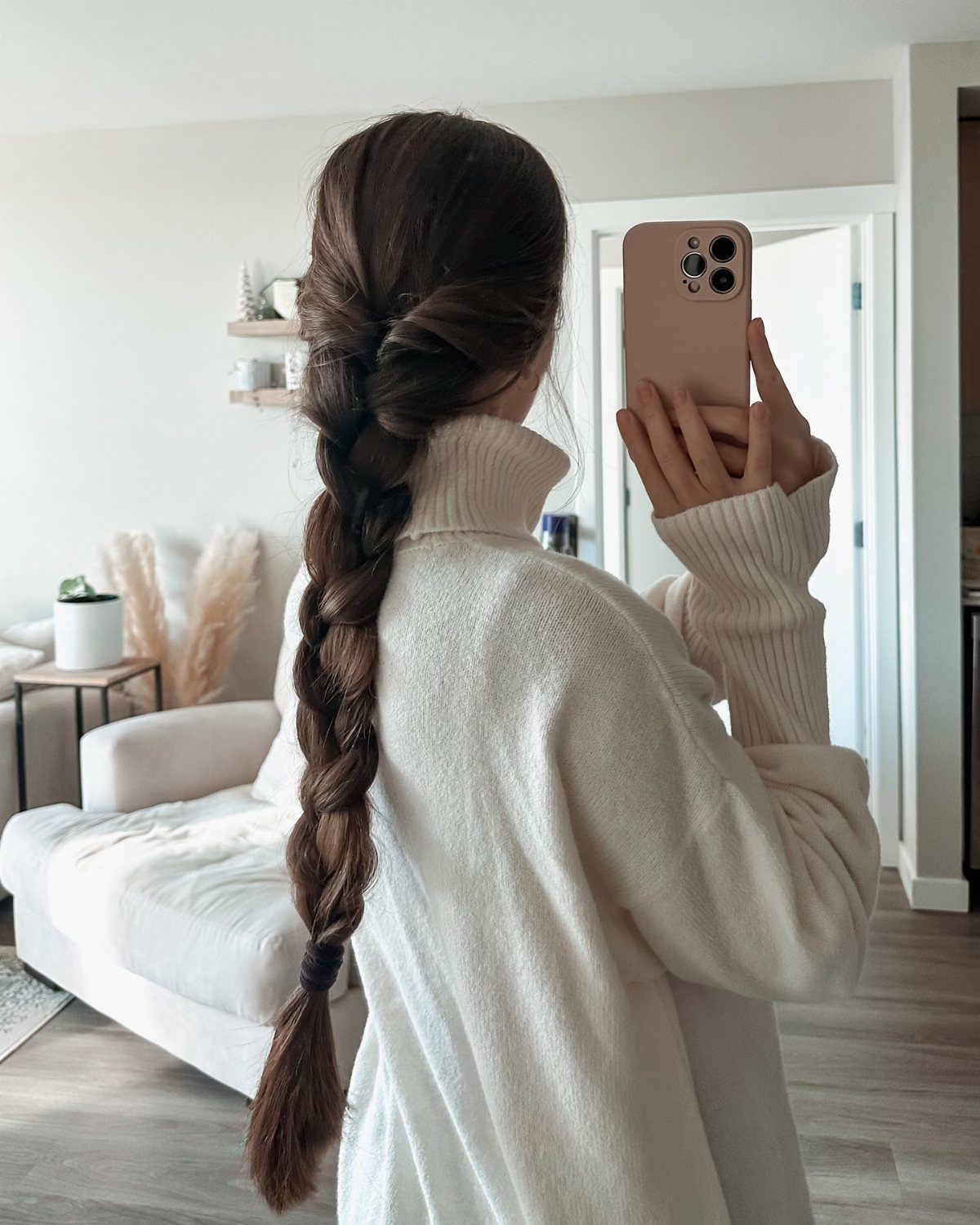 12 Braids Hairstyles: 29 Ideas, From Box Braids to Milkmaid 17 Woman with a loose, voluminous brown messy braid wearing a white turtleneck sweater.