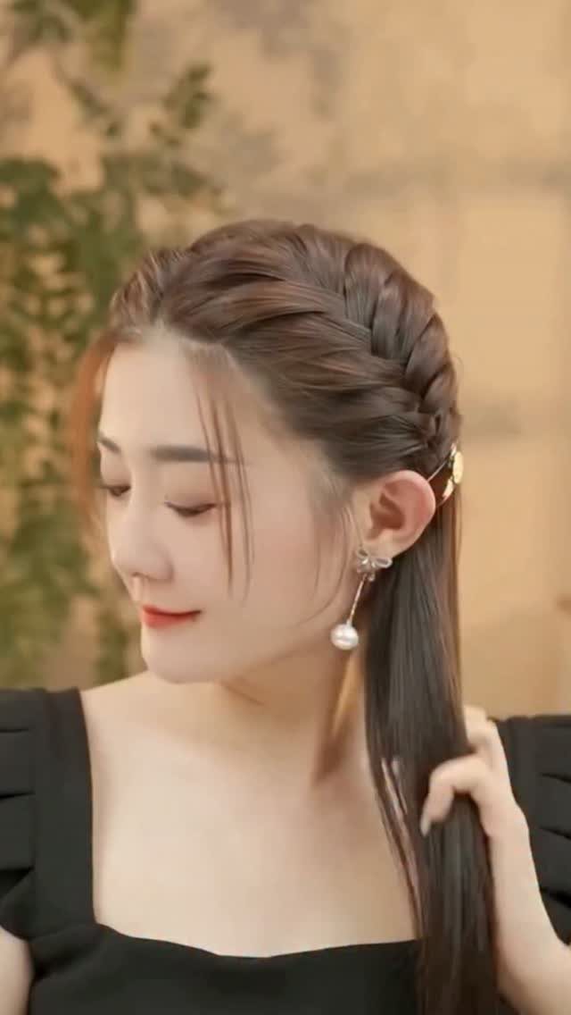 12 Braids Hairstyles: 29 Ideas, From Box Braids to Milkmaid 19 Woman with a side braid hairstyle and long brown hair wearing pearl earrings.
