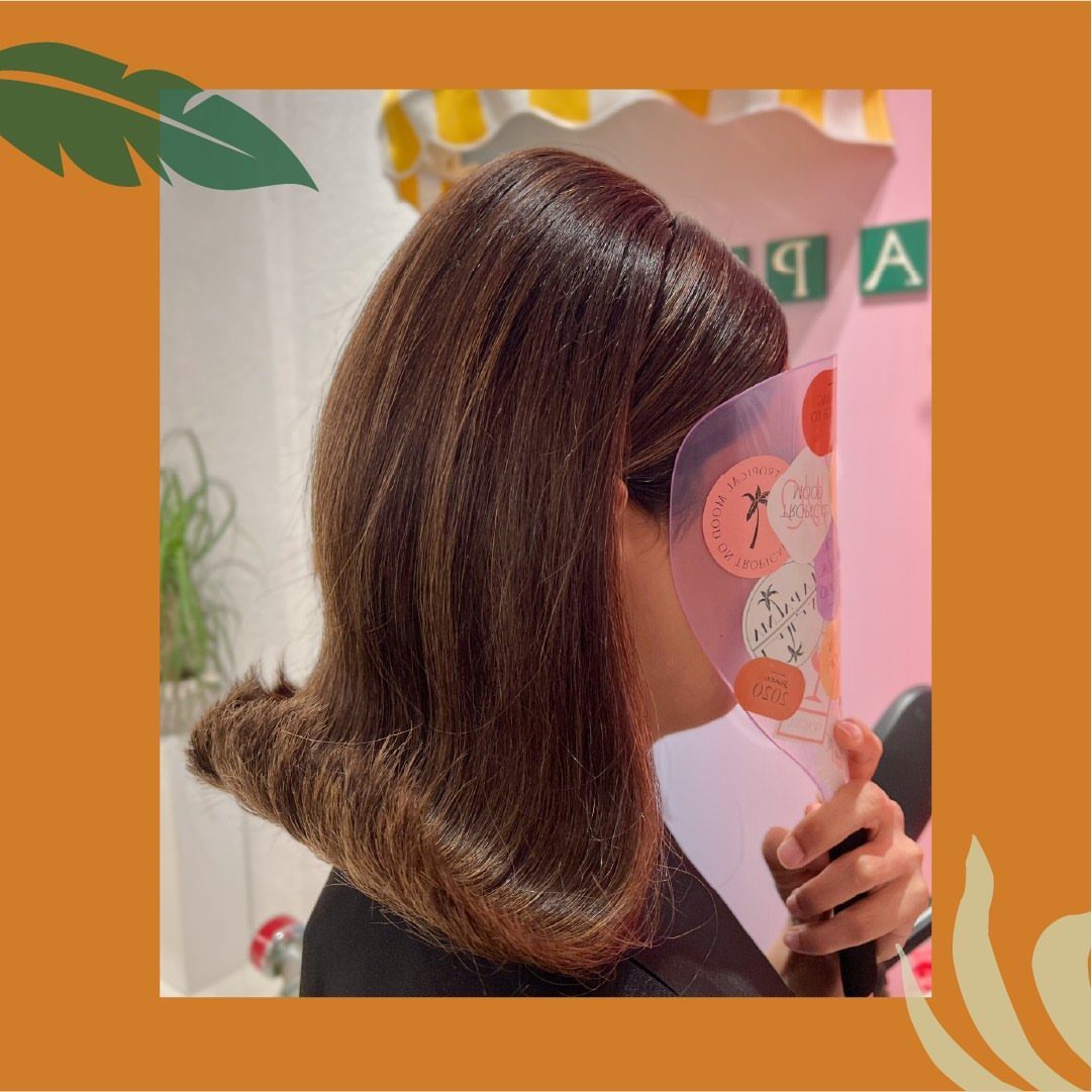 1960s Hairstyles: 7 Ideas from Beehives to Bubble Cuts 3 Brown medium-length hair styled with ends curled outward in a classic flip.