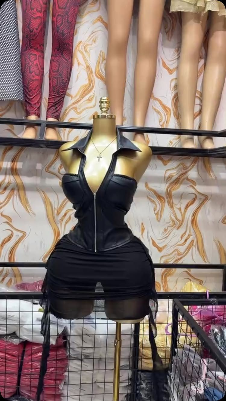 Black leather corset with zipper and collar on a gold mannequin torso