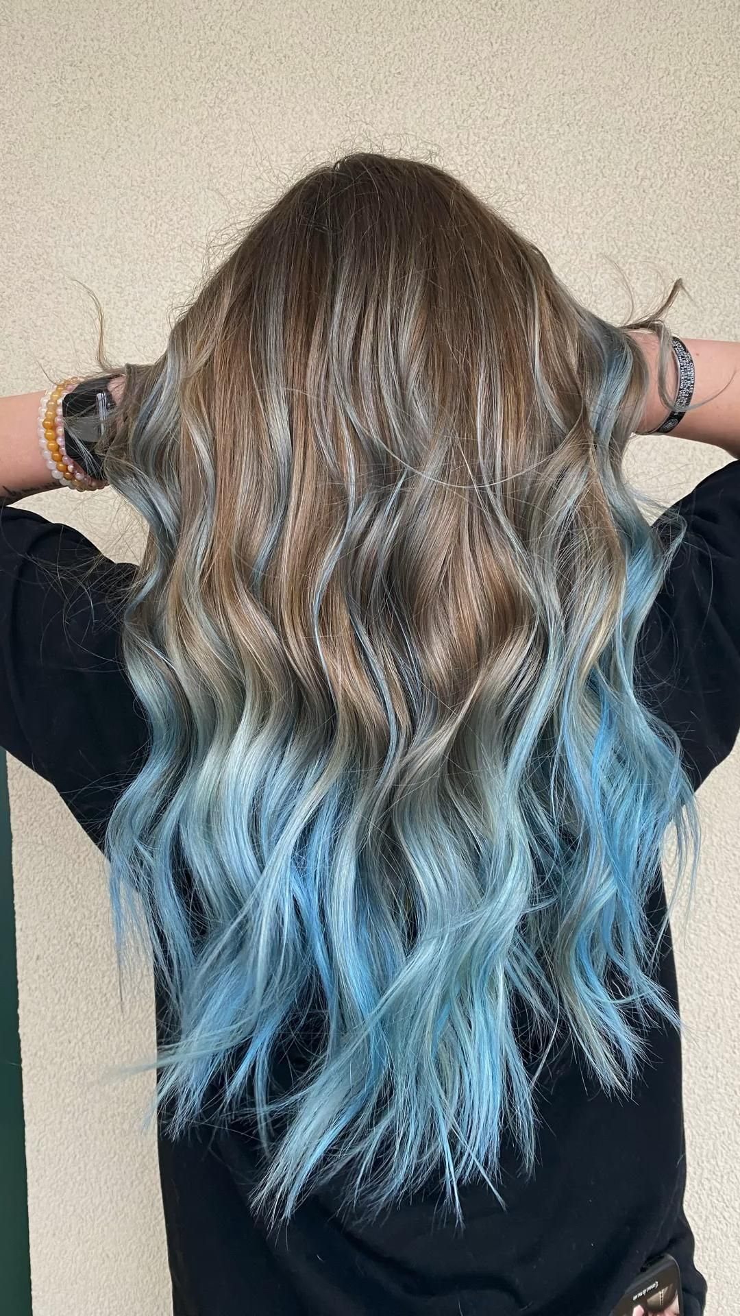 8 Blue Highlights for Brown Hair Ideas and Styles 3 Long wavy light brown hair with pastel blue highlights and ombre ends.
