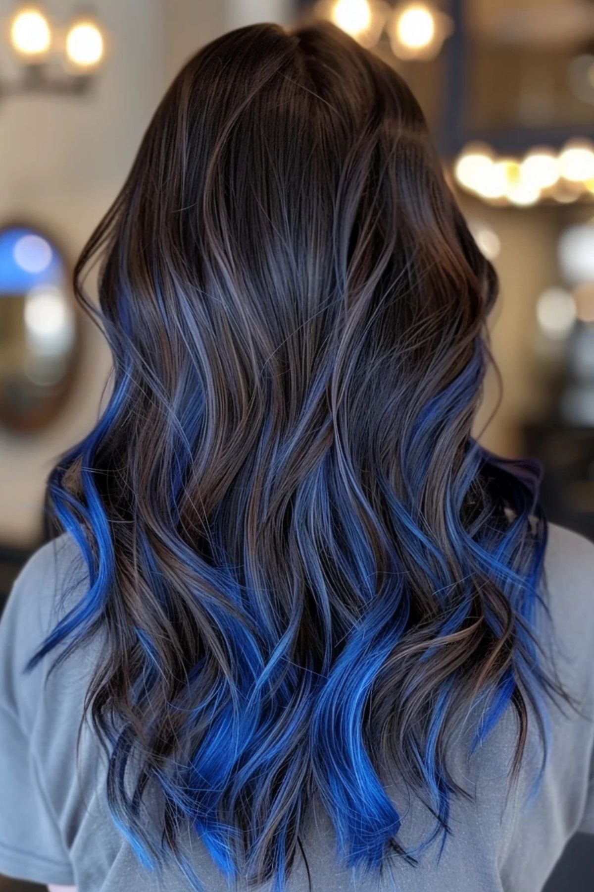 8 Blue Highlights for Brown Hair Ideas and Styles 6 Wavy medium brown hair with vibrant royal blue highlights from mid-length to ends.