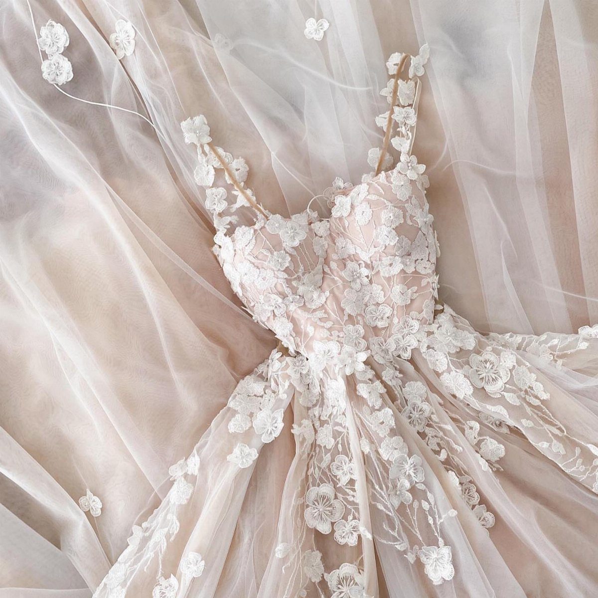 25 Blush Wedding Dress Ideas in Lace, Tulle, Silk and Sequins 18 Blush wedding dress with white floral lace appliqués and layered tulle fabric.