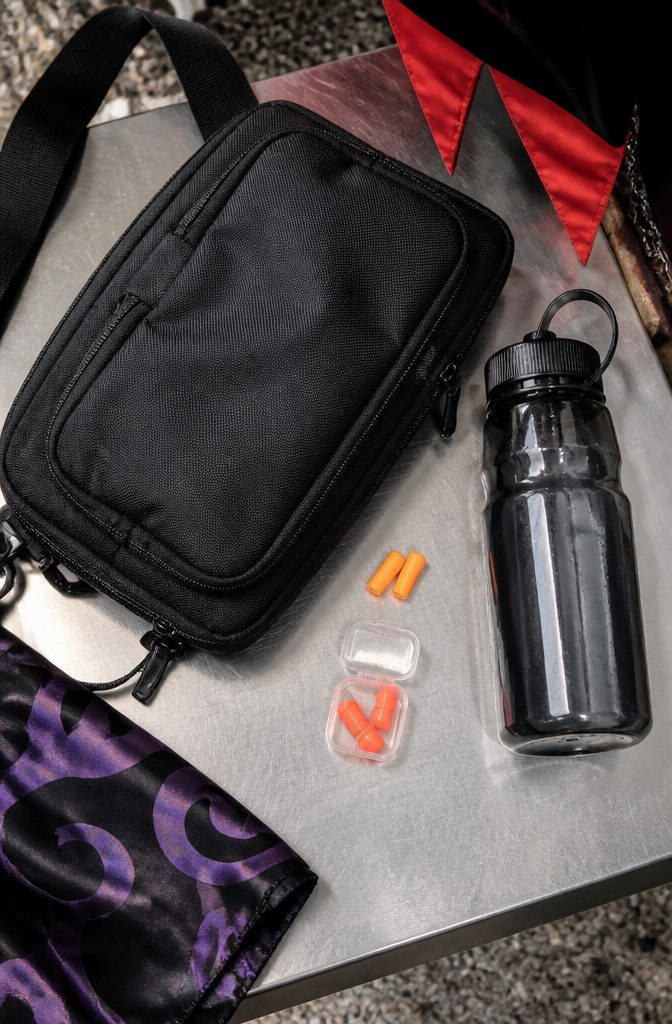 An image showing a small crossbody bag and reusable earplugs for Halloween Horror Nights.