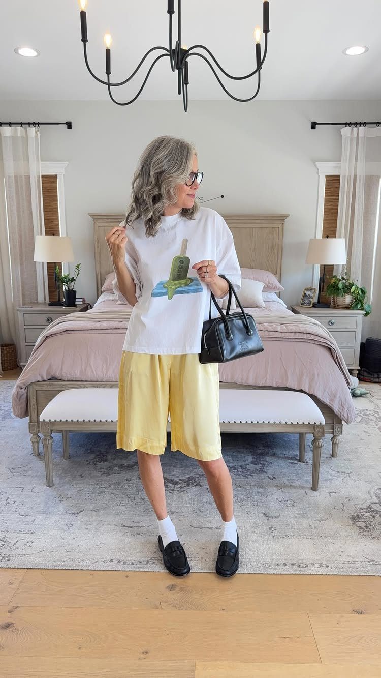 Casual Outfits for Las Vegas: 35 Ideas for Day and Night 19 Woman wearing a white graphic t-shirt and yellow wide-leg cropped pants in a bedroom.
