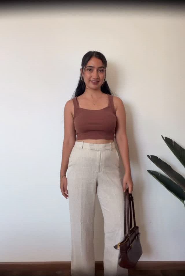 Casual Outfits for Las Vegas: 35 Ideas for Day and Night 5 Woman wearing a brown crop top and wide-leg off-white linen pants with handbag.