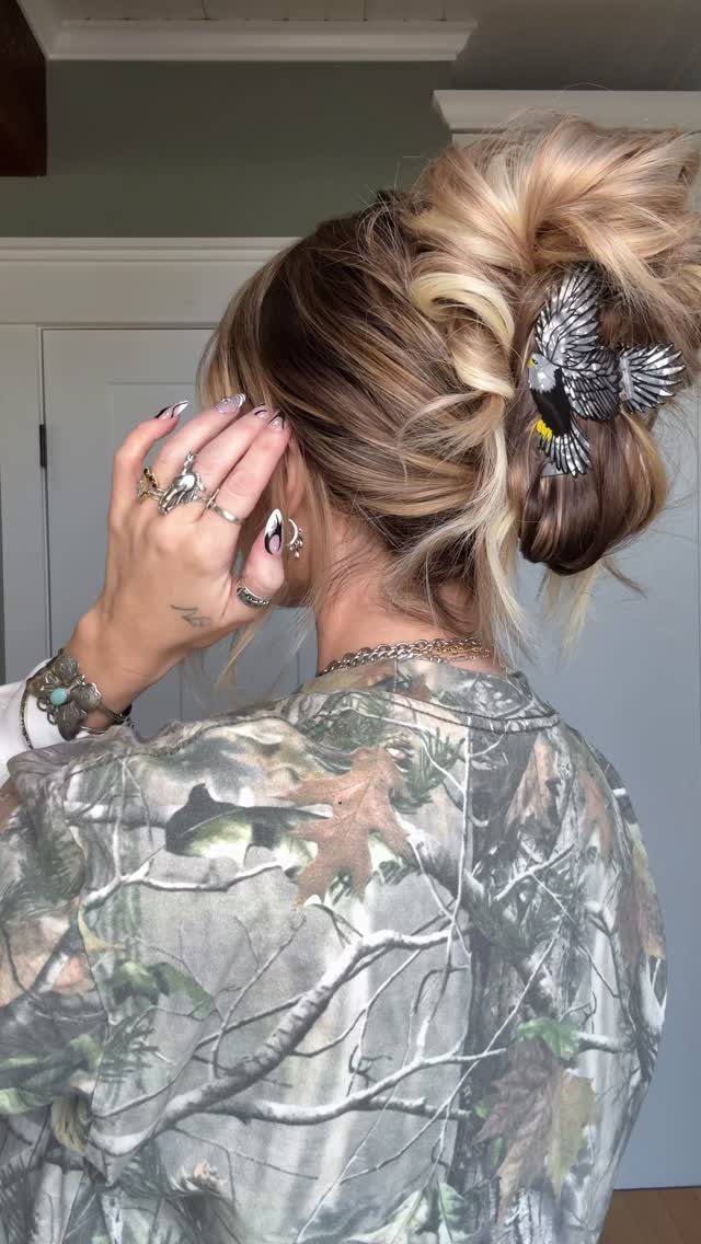 11 Clip Up Hairstyles From French Twists to Half-Up Buns 12 Blonde hair in a messy updo secured with a bird-shaped hair clip