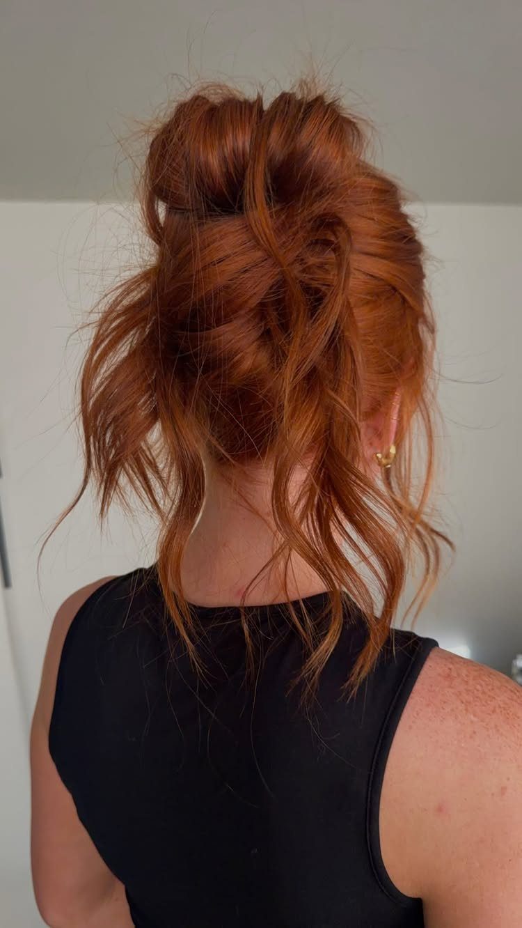 11 Clip Up Hairstyles From French Twists to Half-Up Buns 5 Red hair styled in a messy French twist updo with loose strands.