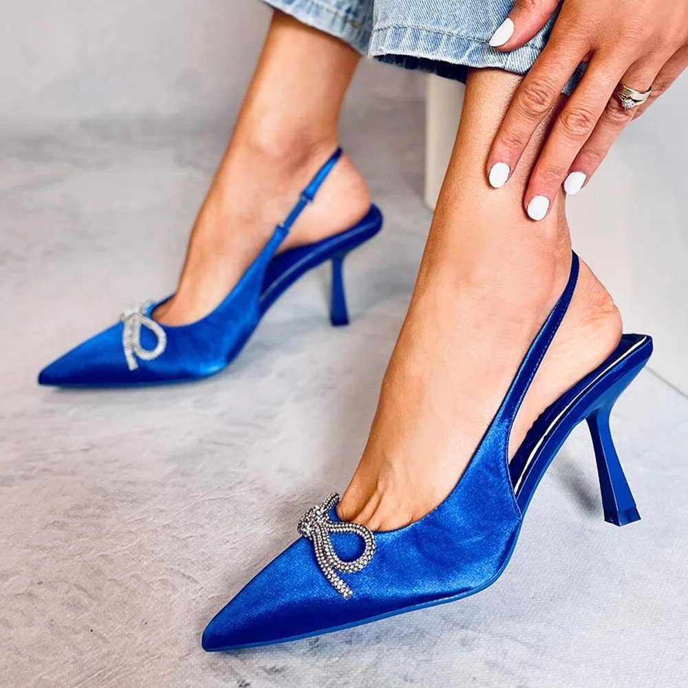 Royal blue satin slingback pumps with rhinestone bows and pointed toes.