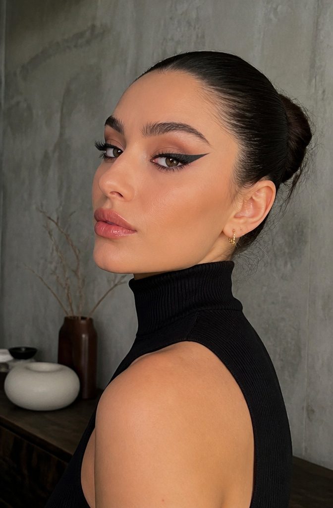 20 Cool Makeup Looks: Creative Ideas to Try in 2026 17 Model showcasing a thick, bold winged eyeliner look.