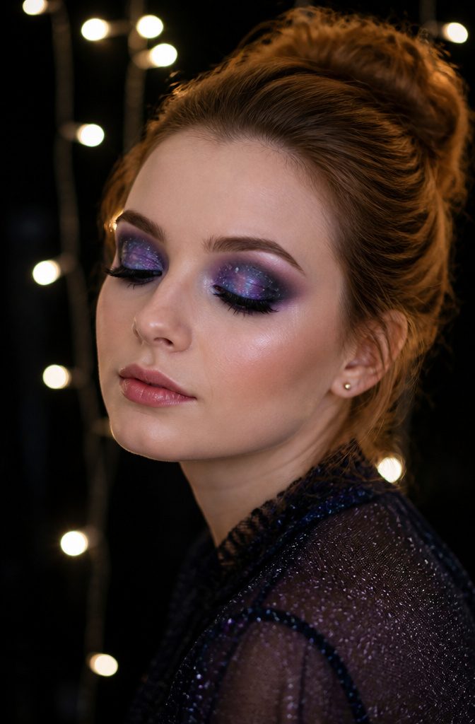 20 Cool Makeup Looks: Creative Ideas to Try in 2026 7 Model showcasing galaxy-inspired eye makeup with stars and dark hues.