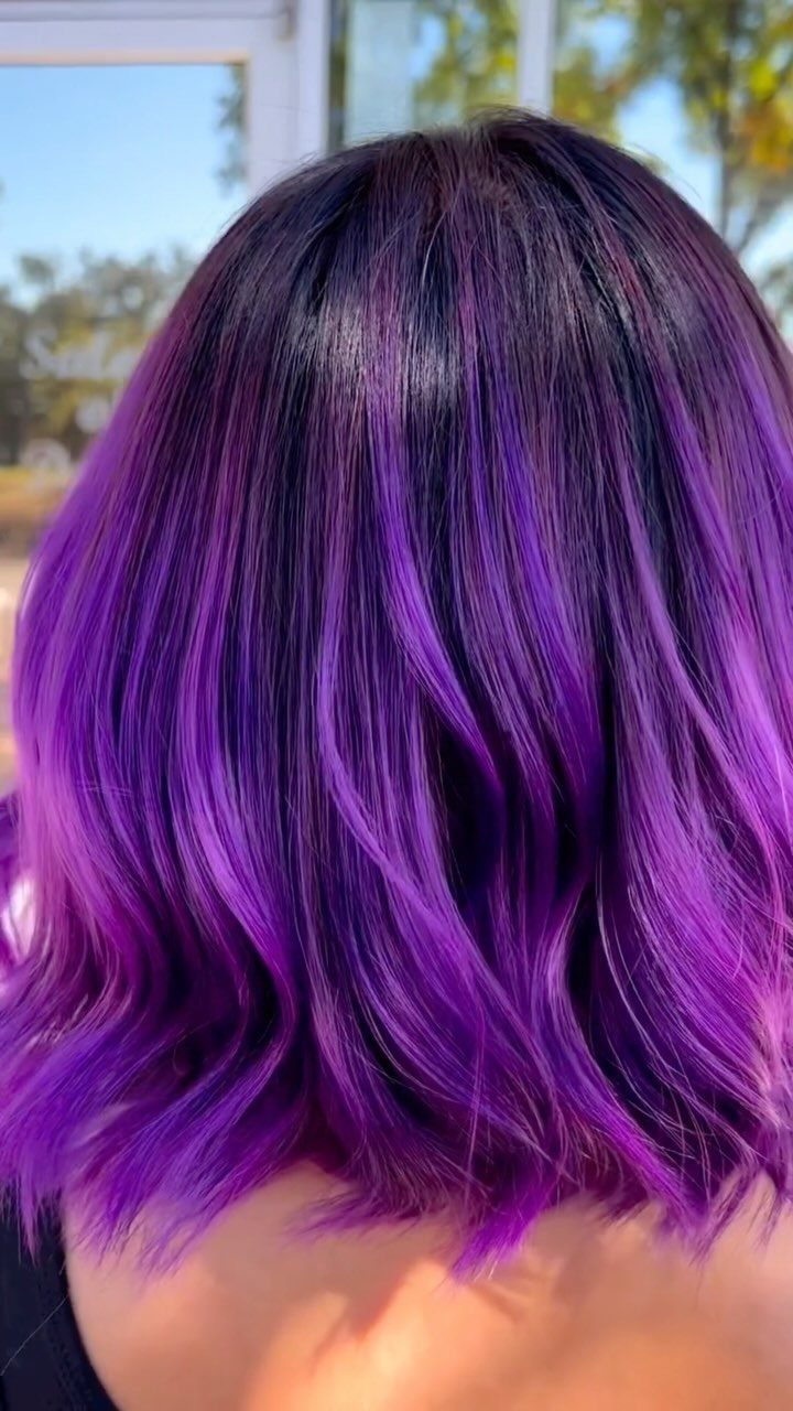 Dark Winter Hair Color: 9 Shades From Black to Burgundy 8 Vibrant purple and black wavy hair seen from the back in bright sunlight.