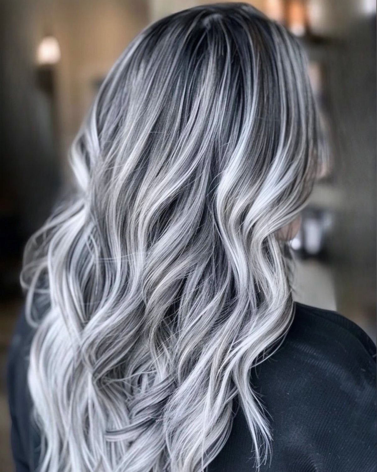 Dark Winter Hair Color: 9 Shades From Black to Burgundy 6 Long wavy hair with high-contrast icy platinum highlights over a dark base.