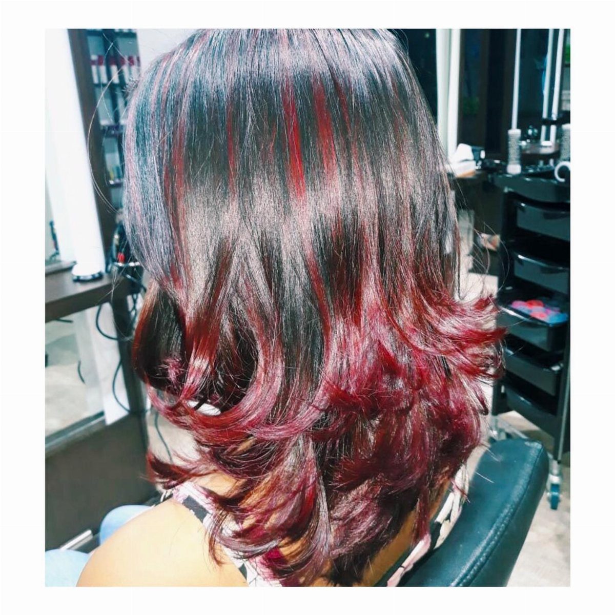Dark Winter Hair Color: 9 Shades From Black to Burgundy 5 Dark black hair with vibrant red and burgundy highlights styled in voluminous curls