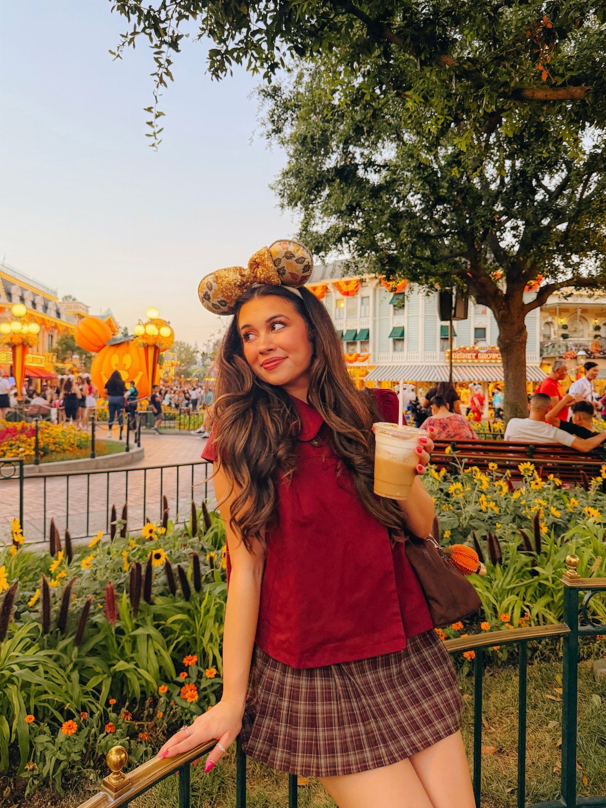 29 Fall Outfits Teens Can Copy, From Grunge to Cowgirl Looks 14 Young woman in Mickey ears, red shirt, and plaid skirt at Disney park.