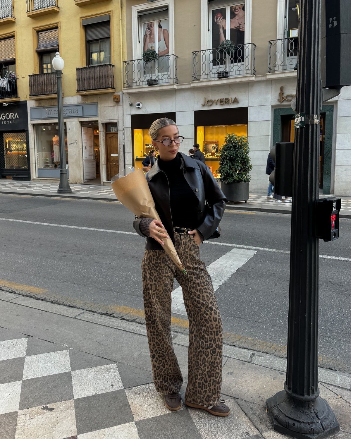 29 Fall Outfits Teens Can Copy, From Grunge to Cowgirl Looks 8 Person in leopard print pants, black leather jacket, and turtleneck on city street