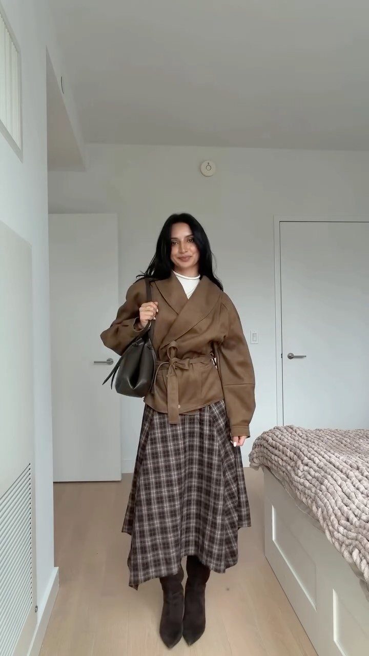 29 Fall Outfits Teens Can Copy, From Grunge to Cowgirl Looks 27 Young woman wearing a brown wrap jacket and a plaid midi skirt.