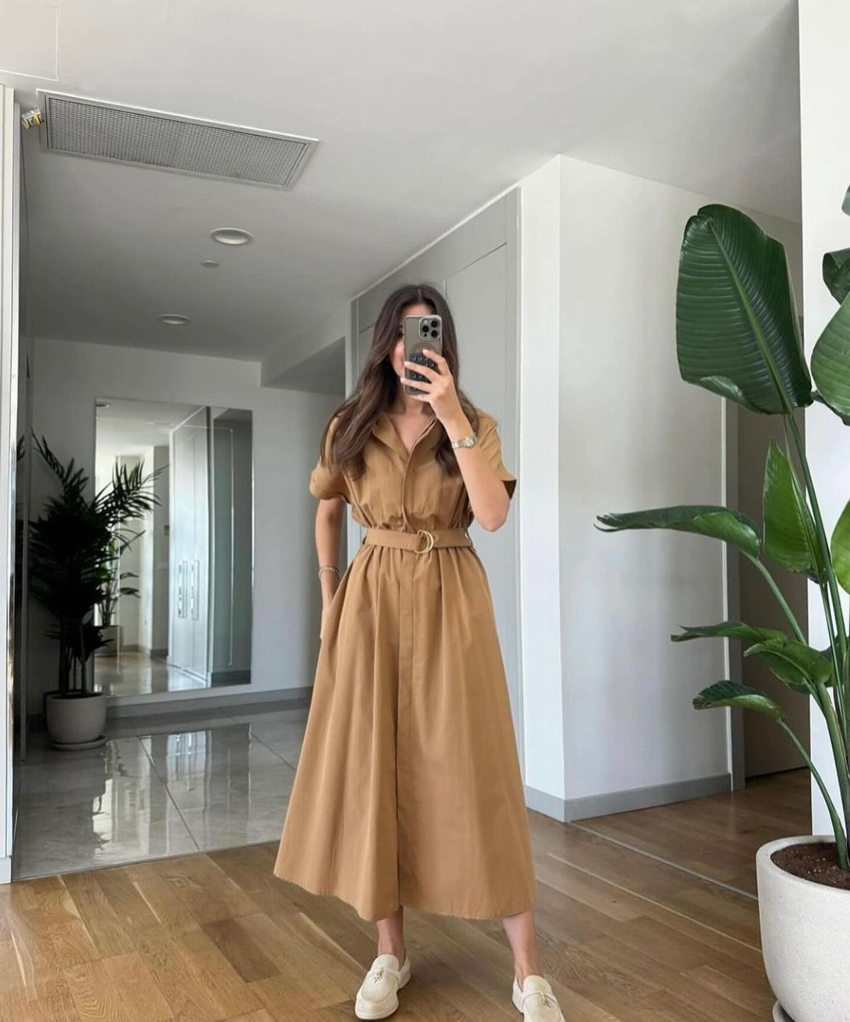 Formal Casual Dresses: 20 Ideas From Shirt Dresses to Velvet 18 Woman in a tan belted midi dress and white sneakers taking a mirror selfie.