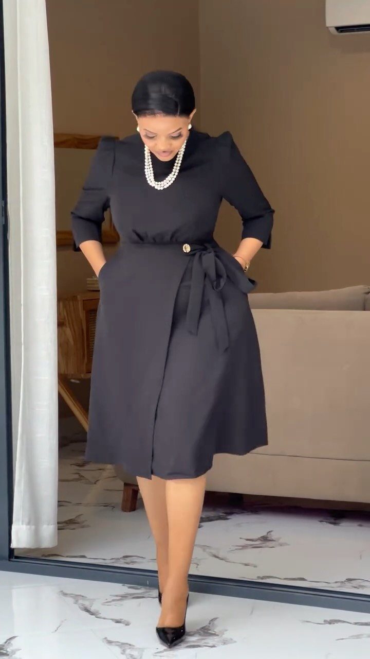 Formal Casual Dresses: 20 Ideas From Shirt Dresses to Velvet 3 Woman wearing a black midi formal dress with a pearl necklace and black heels.