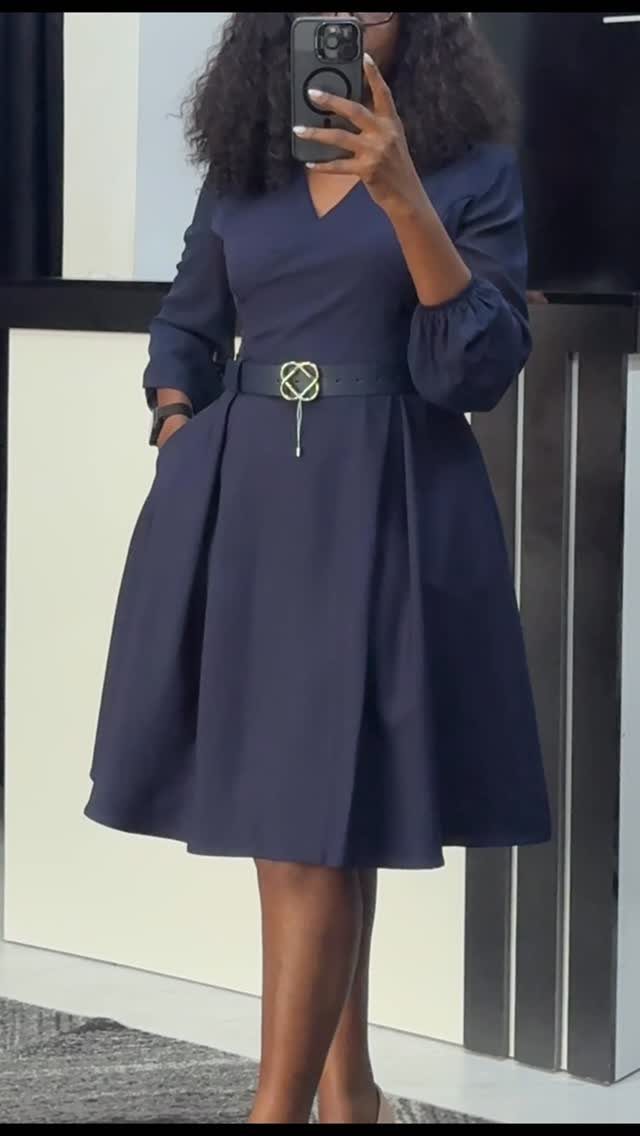 Formal Casual Dresses: 20 Ideas From Shirt Dresses to Velvet 6 Woman in a navy blue fit and flare dress with a black gold-buckle belt.