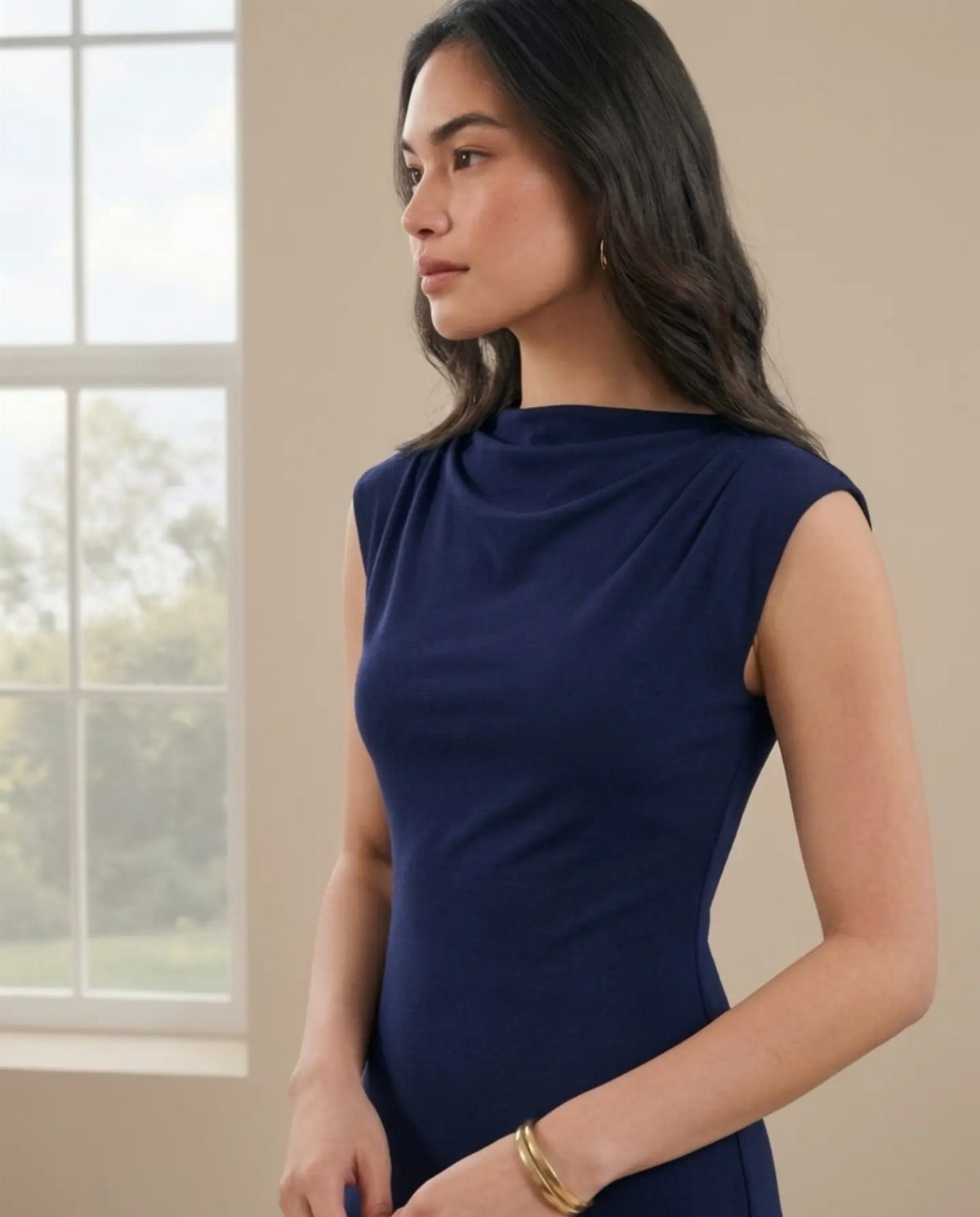 Formal Casual Dresses: 20 Ideas From Shirt Dresses to Velvet 20 Woman wearing a sleeveless navy blue high-neck dress standing by a window
