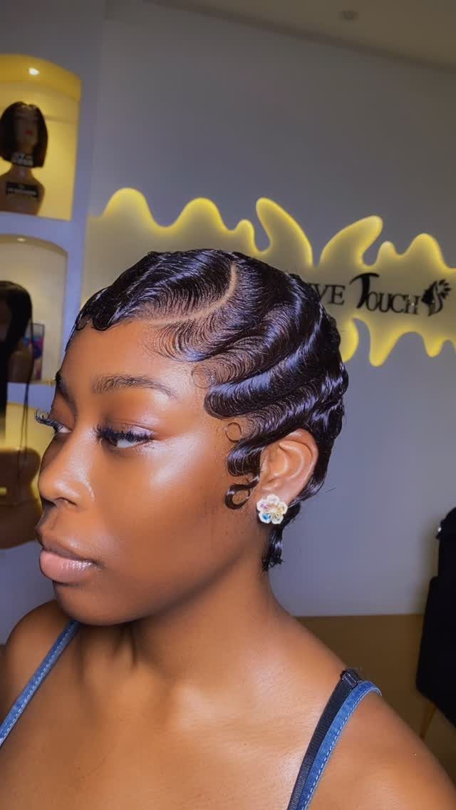 16 Good Hairstyles for Curly Hair, From Pixie to Long Layers 7 Woman with dark hair styled in structured, glossy Art Deco finger waves.