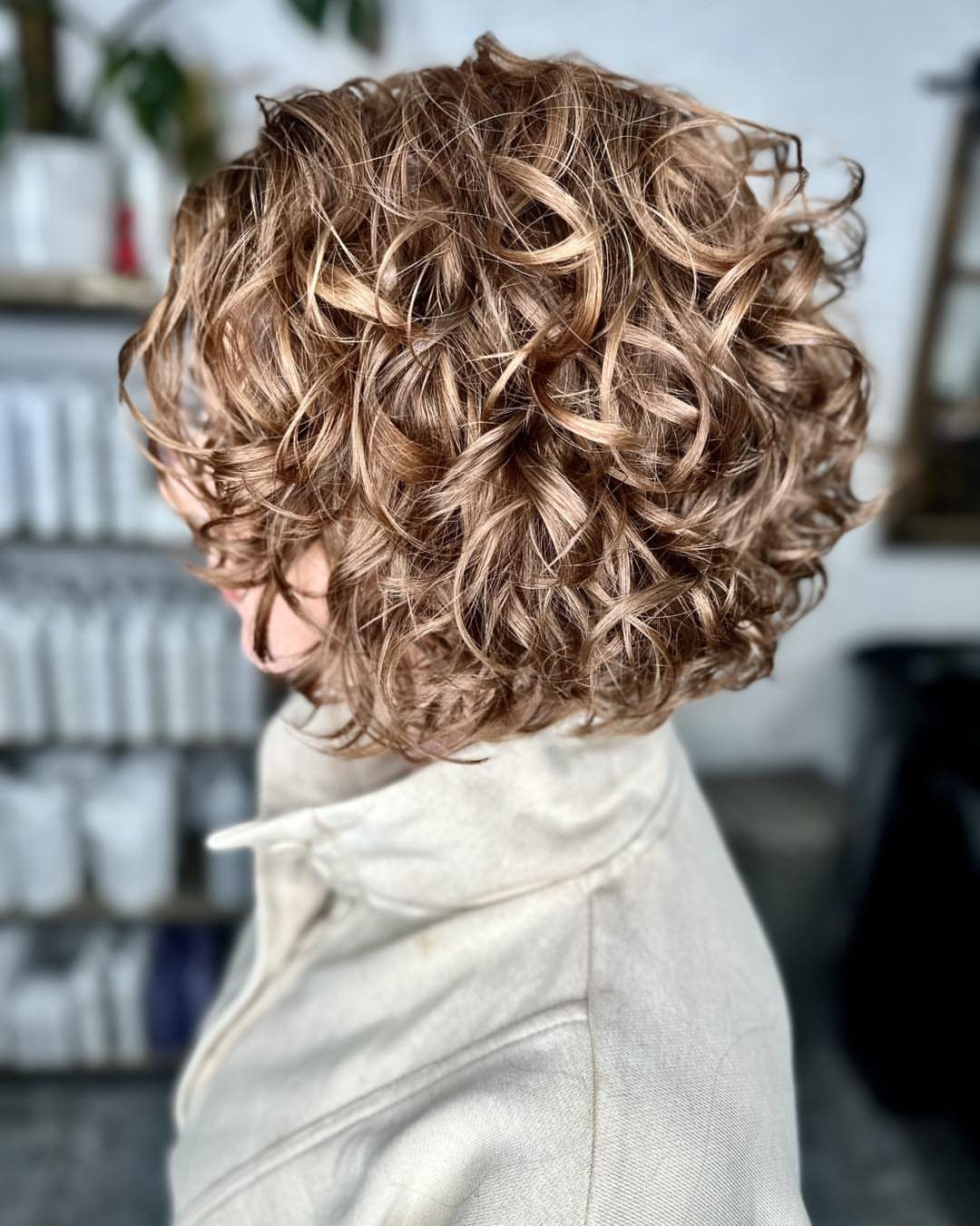 16 Good Hairstyles for Curly Hair, From Pixie to Long Layers 13 Short curly bob haircut with golden blonde highlights on light brown hair.