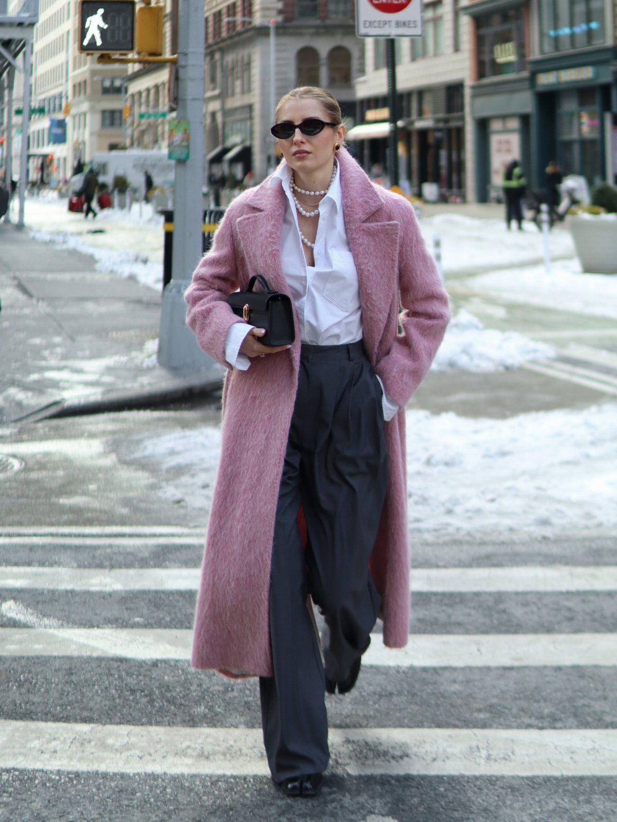 10 Grey Dress Pants Outfit Ideas for Work and Weekends 7 Woman in pink coat and grey wide-leg dress pants walking on city street