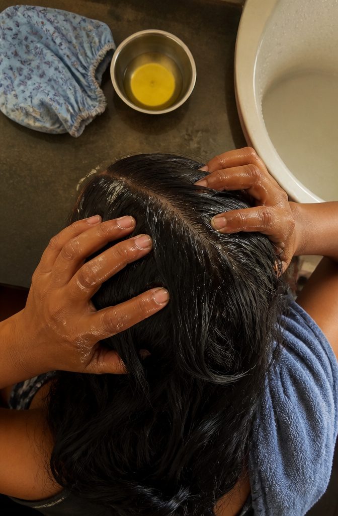 Fingertips massaging the scalp during a hair care routine