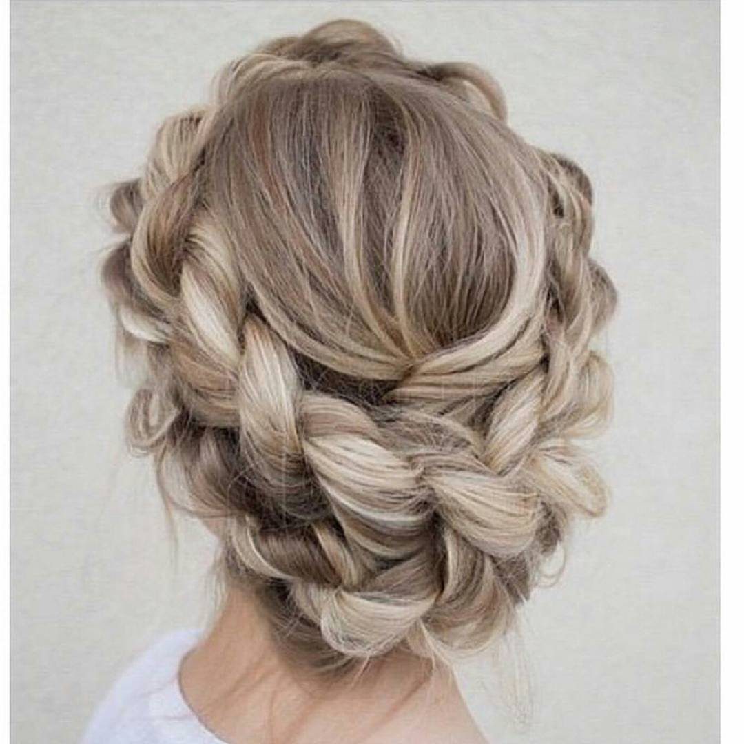 Blonde hair styled in a thick braided crown wrapping around the back of the head.