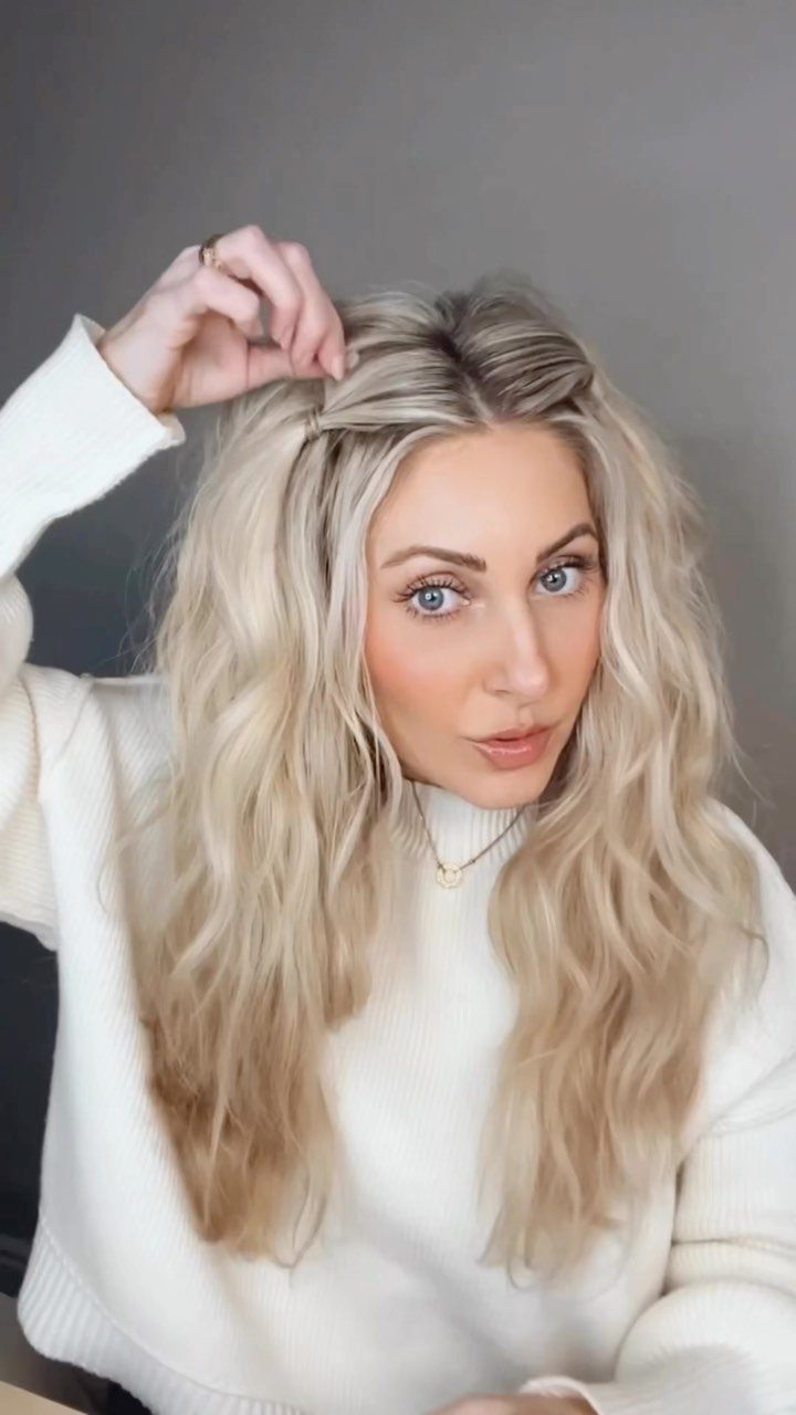 12 Hairstyles to Hide Bangs, From Quick Sweeps to Sleek Buns 9 Woman with blonde wavy hair pinning back her bangs with a hair clip