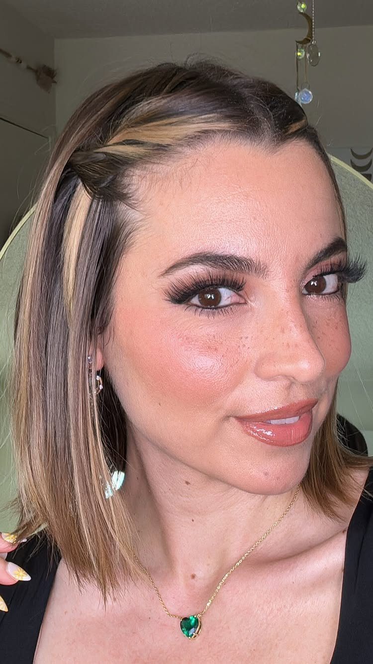 12 Hairstyles to Hide Bangs, From Quick Sweeps to Sleek Buns 3 Woman with blonde highlights and bangs twisted and pinned back from her forehead.
