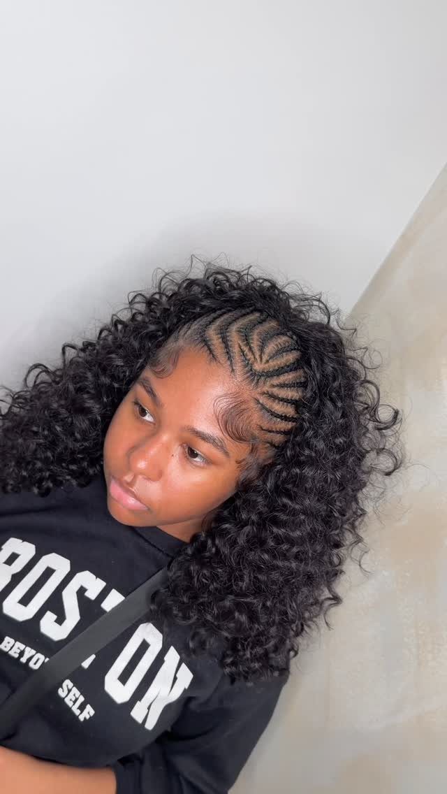7 Half Braid Half Curly Hairstyles for Braids Mixed With Curls 6 Woman with a hairstyle combining cornrow braids and voluminous tight curly hair.