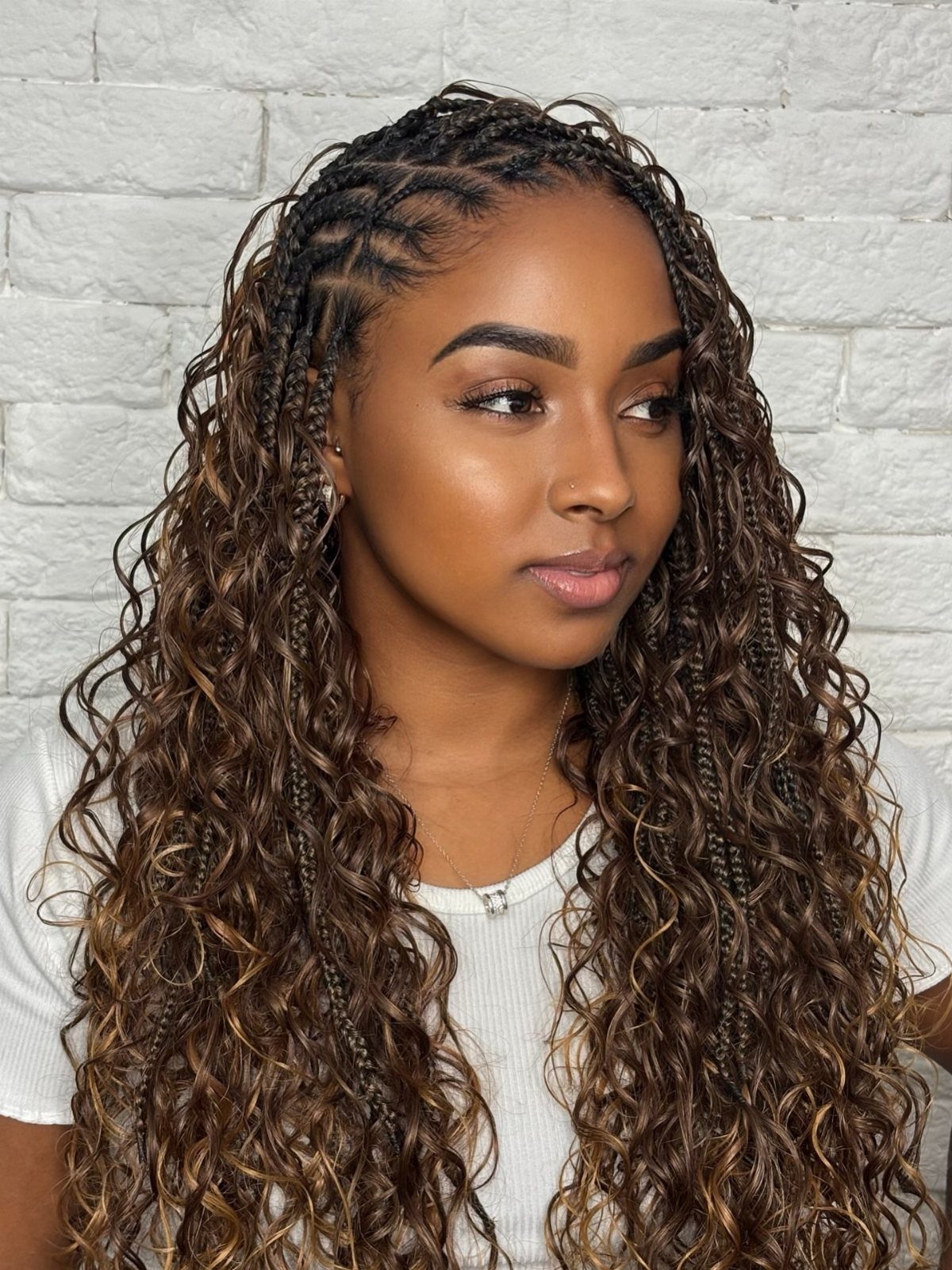 7 Half Braid Half Curly Hairstyles for Braids Mixed With Curls 8 Woman with a hairstyle combining thin braids and long brown curly hair.