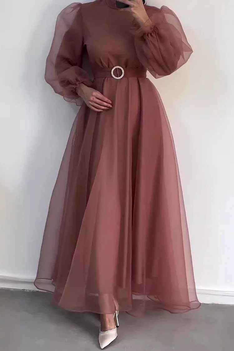 Mauve long sleeve ball dress with sheer puff sleeves and a belted waist.