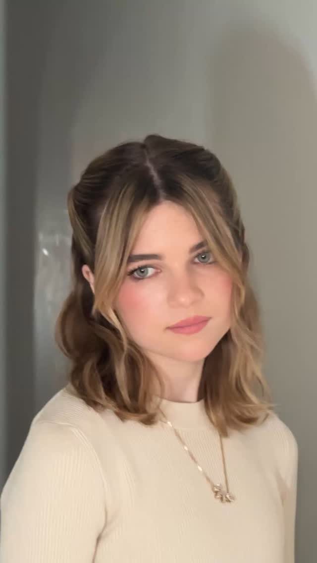 18 Medium Length Curly Hair Hairstyles, From Bobs to Shags 16 Woman with blonde wavy hair styled in a curly half-up hairstyle.