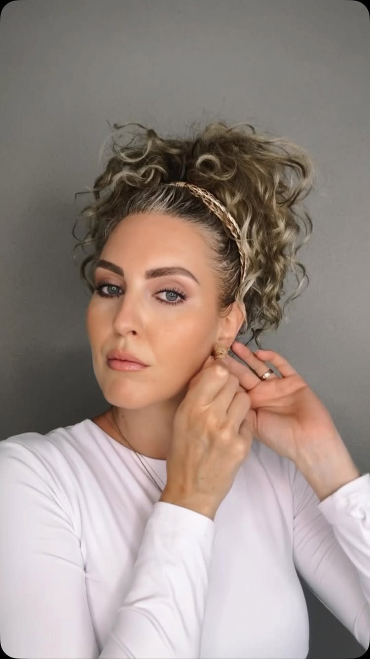 18 Medium Length Curly Hair Hairstyles, From Bobs to Shags 2 Woman with curly blonde hair in a high messy bun and gold headband