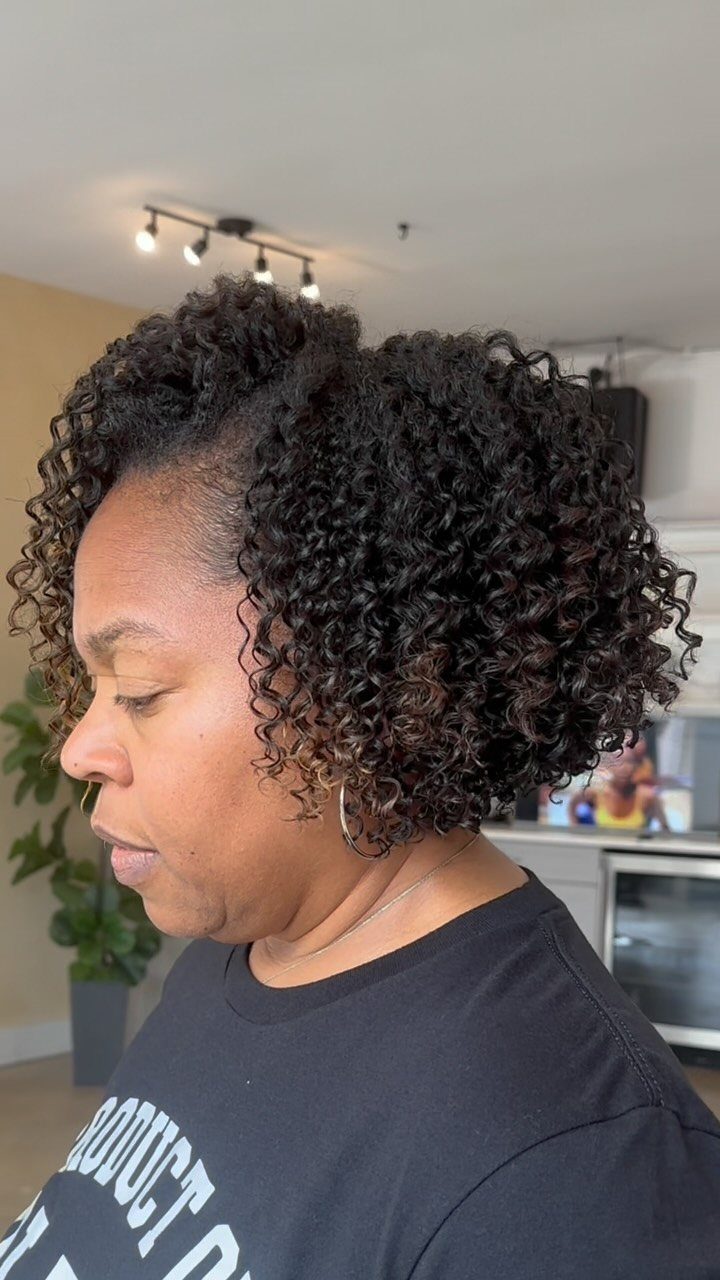18 Medium Length Curly Hair Hairstyles, From Bobs to Shags 6 Woman with dark, tight curly hair in a textured shoulder-length cut.