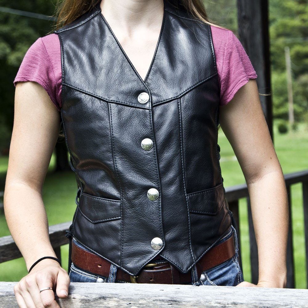 Metal Festival Outfit Ideas for Women: 10 Bold Looks to Try 8 Woman wearing a black leather vest over a purple shirt and blue jeans.