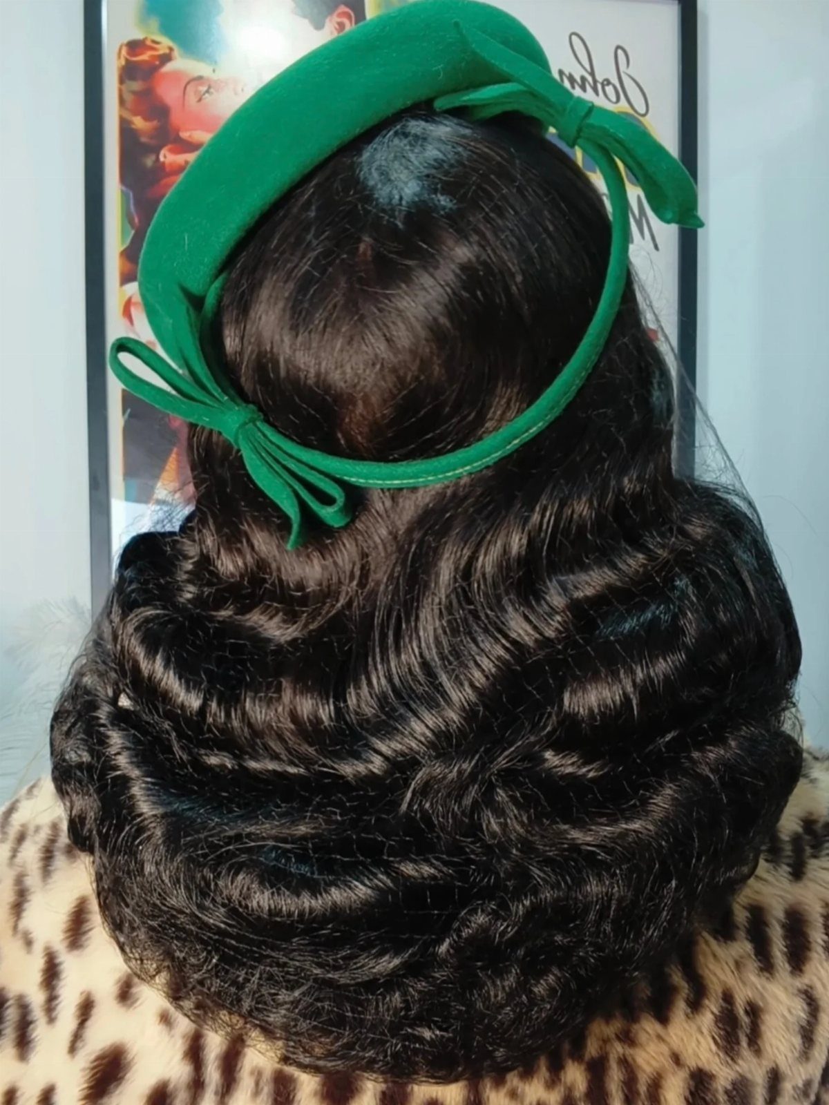 Pin Up Curls Hairstyles: 7 Ideas From Victory Rolls to Bows 7 Dark brown hair styled in vintage waves with a green bow headband.