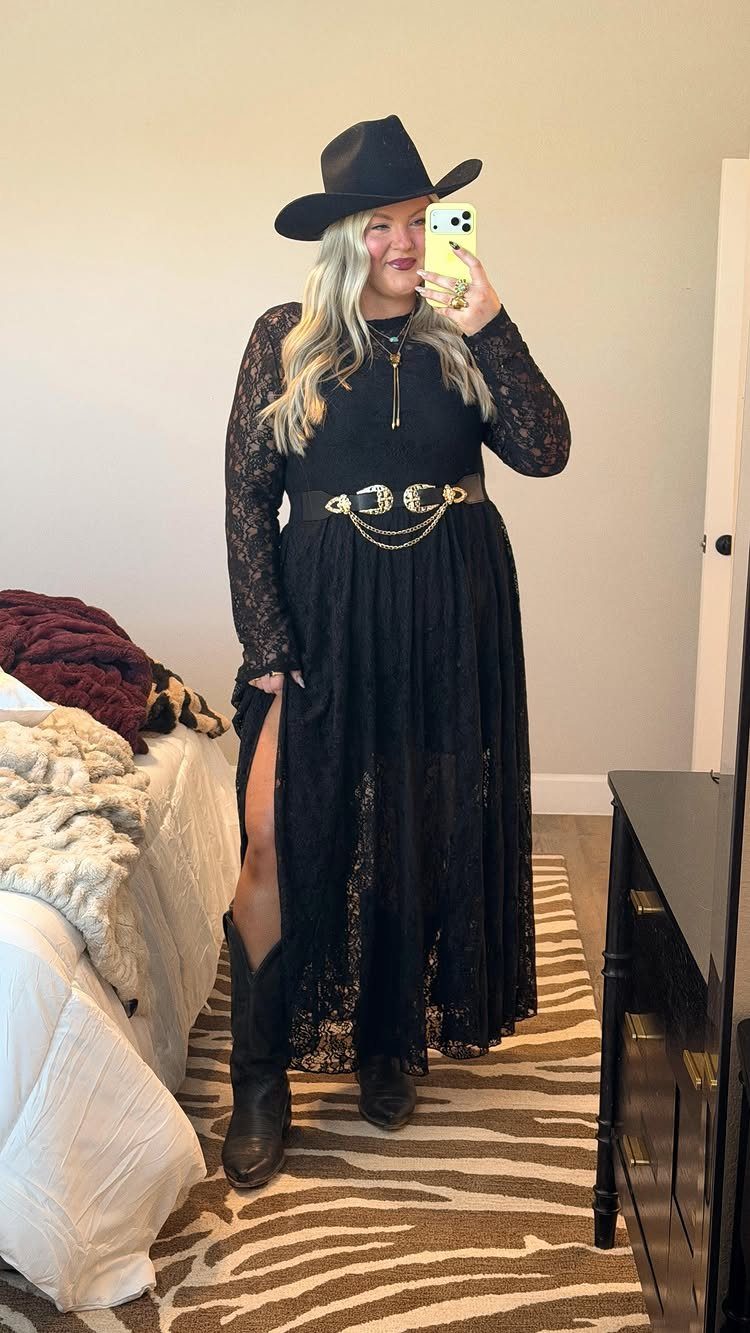 29 Rodeo Inspired Outfits Built on Fringe, Denim, and Boots 8 Woman in black lace dress, cowboy hat, and boots posing for a mirror selfie.
