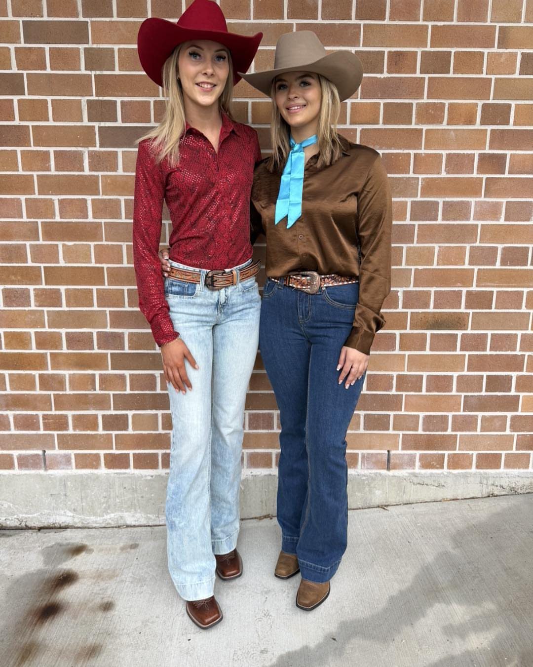 29 Rodeo Inspired Outfits Built on Fringe, Denim, and Boots 15 Two women in western wear, one wearing a brown satin shirt and dark jeans.