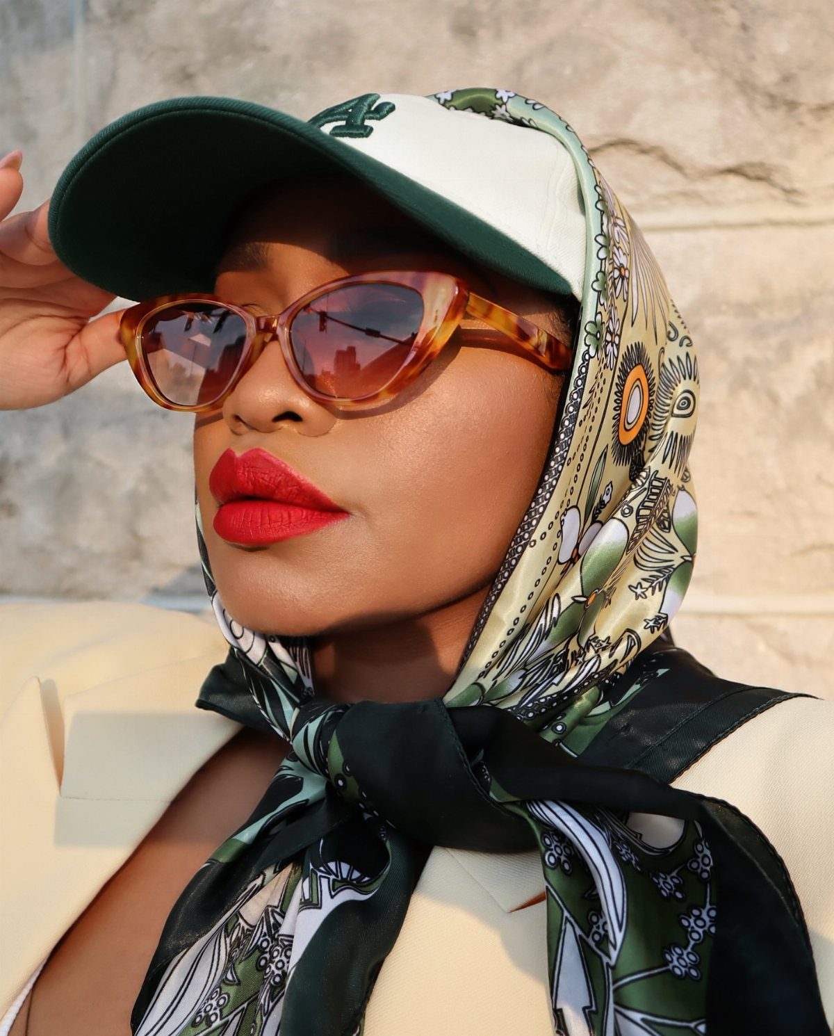 Semi Casual Clothes: 31 Outfit Ideas From Dresses to Loafers 31 Woman wearing a patterned silk headscarf, baseball cap, and brown cat-eye sunglasses.